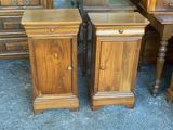 two nightstands that are next to each other on the floor