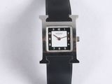 an image of a black and white watch on a white surface