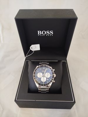 a close up of a watch in a box on a white surface