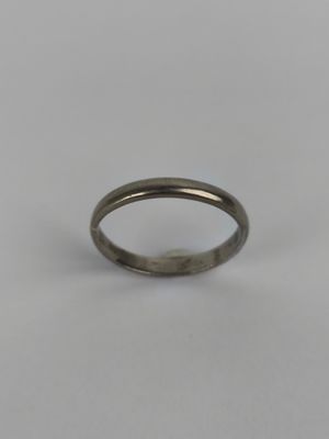 a close up of a silver ring on a white surface