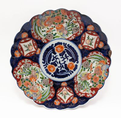 a blue and orange plate with a flower design on it