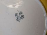 a close up of a yellow plate with a bird on it