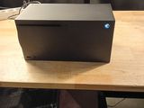 a black box sitting on top of a wooden table