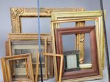 a lot of picture frames that are sitting on a table