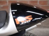 a close up of a motorcycle parked in front of a brick wall