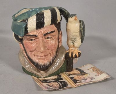 a ceramic figurine of a man with a bird on his arm