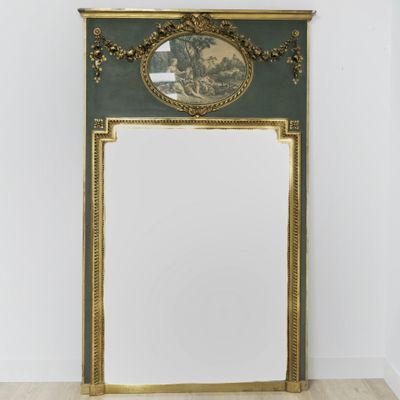 an ornately decorated mirror in the corner of a room
