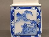 chinese blue and white porcelain jar with a mountain scene on the lid