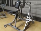 a gym room with a wall that has progress written on it