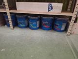 many buckets of paint on the shelves in the store