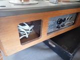 a microwave that is sitting inside of a wooden cabinet
