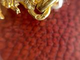 a close up of a gold plate with a dragon on it