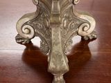 a silver candle holder on a wooden table