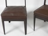 pair of brown leather dining chairs with metal legs and backs