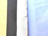 a black and white tie on a table next to a yellow wall