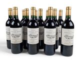 six bottles of red wine are lined up in a row
