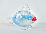 a glass fish that is sitting on a table