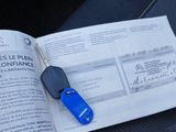 a blue car key sitting on top of an open book