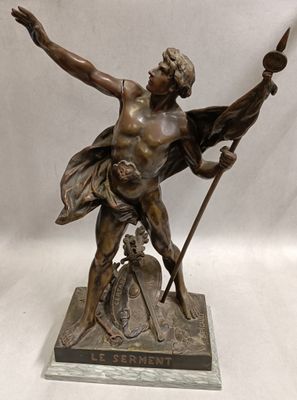 bronze statue of a man with a spear and shield on a base