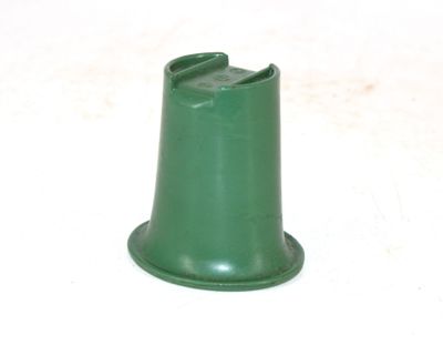 a green plastic cone on a white surface