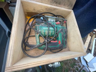 a box with a drill and a cord in it