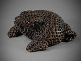 a close up of a figurine of a fish on a gray surface