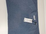 blue knitted scarf with a tag on it laying on a white surface