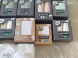 many boxes of toilet paper on the floor next to a pair of shoes