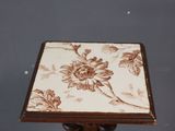 a small table with a flower design on it