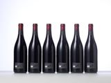 six bottles of red wine lined up in a row