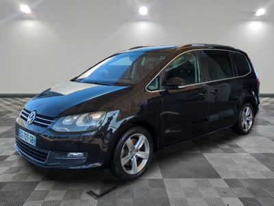 a black vw tourer parked on a checkered tile floor