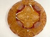 a glass plate with a design on it sitting on a table