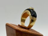 an image of a gold ring with a black stone on it