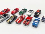 several toy cars are lined up in a row on a white surface