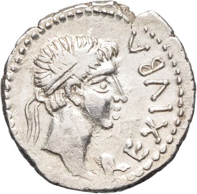 a close up of a silver coin with a woman ' s head on it
