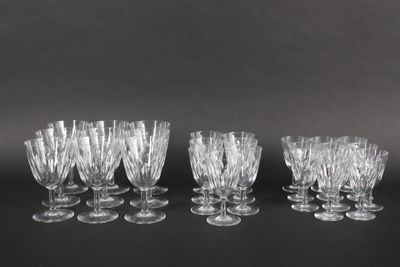 six clear wine glasses lined up on a black surface