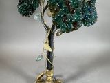 an image of a green and gold lamp with flowers on it