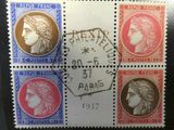 a close up of a stamp with four different faces on it