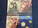 four commemorative coins are sitting on a blue surface