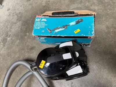 a box of vacuum cleaners and a hose on the floor