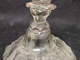 a clear glass vase with a flower on top of it