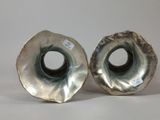 pair of silver plated candlesticks with a black and white design