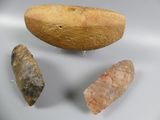 three different types of stone tools displayed on a white surface