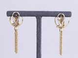 a pair of gold earrings with a chain hanging from them