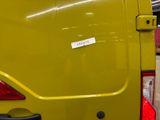 a yellow van that has a sticker on the back of it