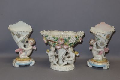 three porcelain vases with cherries and cherries on them on a table