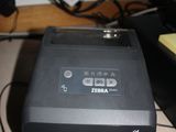 a printer sitting on top of a desk next to a keyboard