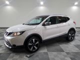 the white nissan suv is parked on a checkered tile floor