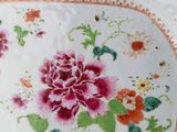 a plate with a floral design on it on a table