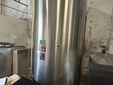 a large stainless steel tank in the middle of a room